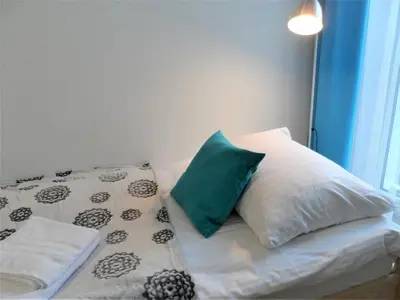 Łóżko lub łóżka w pokoju w obiekcie Apartament Dmowskiego - Kępa Mieszczańska