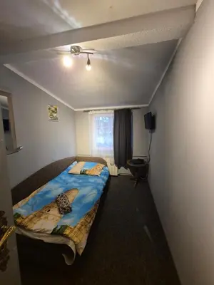 Łóżko lub łóżka w pokoju w obiekcie Zajazd pod Lwem
