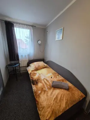 Łóżko lub łóżka w pokoju w obiekcie Zajazd pod Lwem
