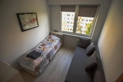 Łóżko lub łóżka w pokoju w obiekcie JDK Apartamenty Podmiejska 38m2 5-osobowy