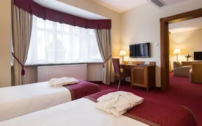 Łóżko lub łóżka w pokoju w obiekcie Bukowy Park Hotel Medical SPA
