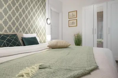 Łóżko lub łóżka w pokoju w obiekcie Cleopatra Apartment