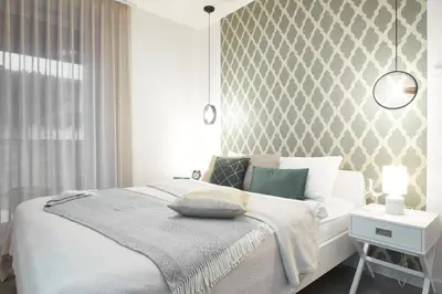 Łóżko lub łóżka w pokoju w obiekcie Cleopatra Apartment