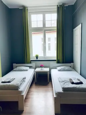 Łóżko lub łóżka w pokoju w obiekcie Chilli Hostel