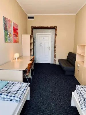 Łóżko lub łóżka w pokoju w obiekcie Chilli Hostel