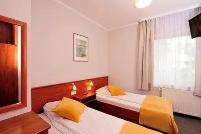 Łóżko lub łóżka w pokoju w obiekcie Hotel Preemier