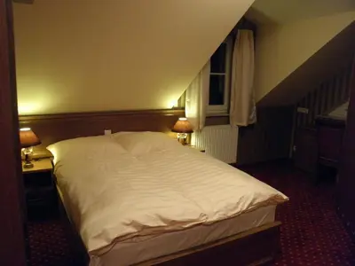 Łóżko lub łóżka w pokoju w obiekcie Rezydencja Pałac Lucja BB