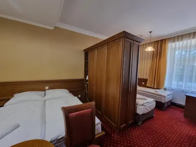 Łóżko lub łóżka w pokoju w obiekcie Rezydencja Pałac Lucja BB