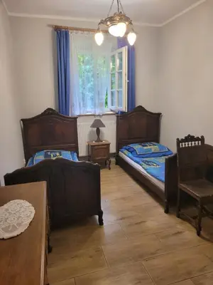 Łóżko lub łóżka w pokoju w obiekcie Gospodarstwo Agroturystyczne Pałac Heymanna - Oficyna