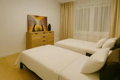 Łóżko lub łóżka w pokoju w obiekcie TK Apartments Spiżowa