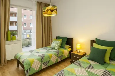 Łóżko lub łóżka w pokoju w obiekcie TK Apartments Spiżowa