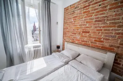 Łóżko lub łóżka w pokoju w obiekcie White Vision Apartment