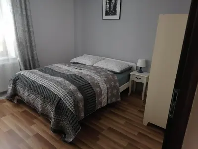 Łóżko lub łóżka w pokoju w obiekcie Apartamenty pod Dzikowcem
