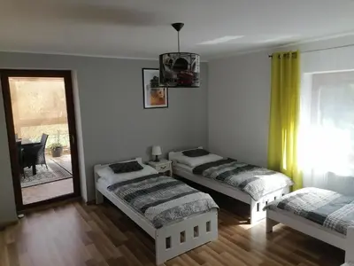 Łóżko lub łóżka w pokoju w obiekcie Apartamenty pod Dzikowcem