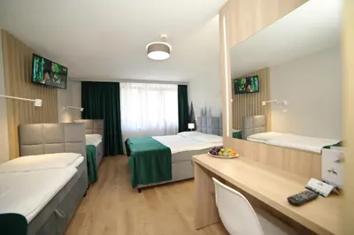 Łóżko lub łóżka w pokoju w obiekcie Ośrodek Wypoczynkowy Pod Dębem