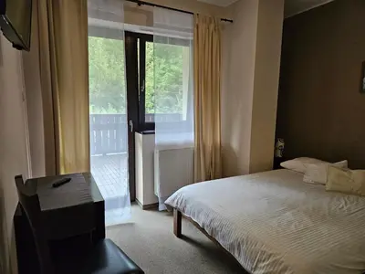Łóżko lub łóżka w pokoju w obiekcie Dom Gościnny Trojak