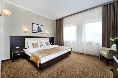 Łóżko lub łóżka w pokoju w obiekcie Hotel Trzebnica