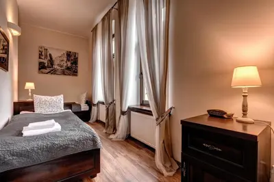 Łóżko lub łóżka w pokoju w obiekcie Hotel Charlotta