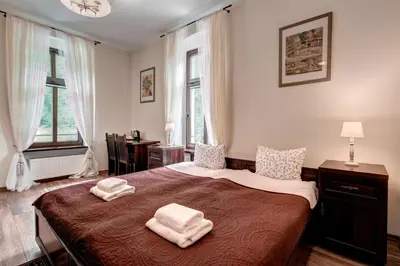 Łóżko lub łóżka w pokoju w obiekcie Hotel Charlotta