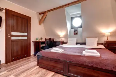 Łóżko lub łóżka w pokoju w obiekcie Hotel Charlotta