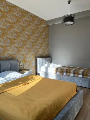 Łóżko lub łóżka w pokoju w obiekcie Apartamenty Dobranocka