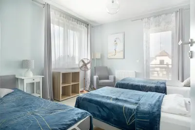 Łóżko lub łóżka w pokoju w obiekcie APARTAMENTY 
