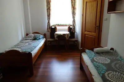 Łóżko lub łóżka w pokoju w obiekcie Dom Pod Siódemką