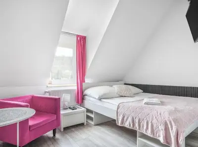 Łóżko lub łóżka w pokoju w obiekcie Parkowy Kudowa