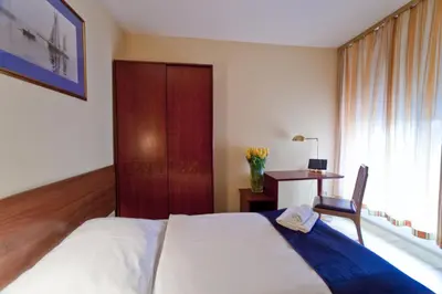 Łóżko lub łóżka w pokoju w obiekcie Apartamenty Pod Lwem