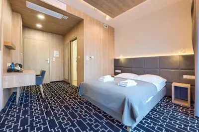 Łóżko lub łóżka w pokoju w obiekcie Hotel Wena