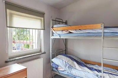Łóżko lub łóżka w pokoju w obiekcie Domek letniskowy