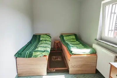 Łóżko lub łóżka w pokoju w obiekcie Domek letniskowy
