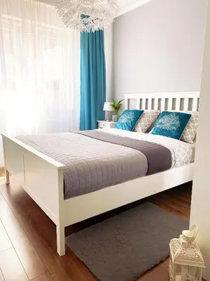 Łóżko lub łóżka w pokoju w obiekcie Apartament na Tęczowej