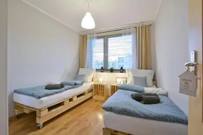 Łóżko lub łóżka w pokoju w obiekcie Apartament Dzień dobry
