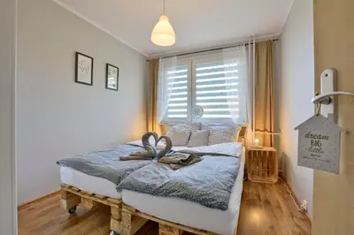 Łóżko lub łóżka w pokoju w obiekcie Apartament Dzień dobry