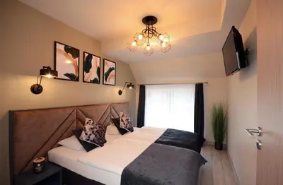 Łóżko lub łóżka w pokoju w obiekcie Apartamenty Biała Sowa Czarna Góra