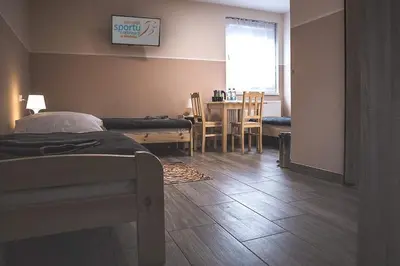 Łóżko lub łóżka w pokoju w obiekcie Dom Wycieczkowy 
