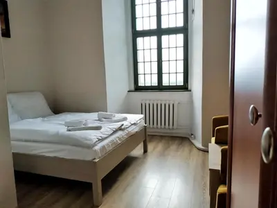 Łóżko lub łóżka w pokoju w obiekcie Zamek Otmuchów