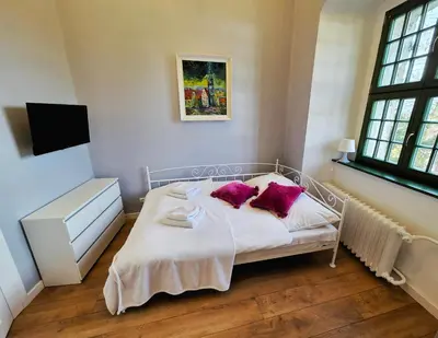 Łóżko lub łóżka w pokoju w obiekcie Zamek Otmuchów