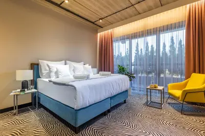 Łóżko lub łóżka w pokoju w obiekcie Hotel Zoo by Afrykarium Wroclaw