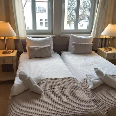 Łóżko lub łóżka w pokoju w obiekcie Villa Lessing