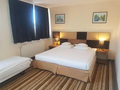Łóżko lub łóżka w pokoju w obiekcie Boutique Hotel's Kwiska - Legnicka