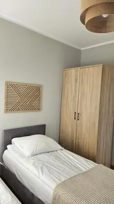 Łóżko lub łóżka w pokoju w obiekcie Marel-Apartamenty w Parku- Rydz Polanica Zdrój