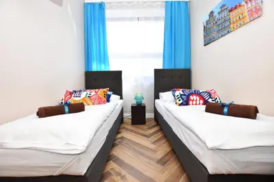 Łóżko lub łóżka w pokoju w obiekcie DUKES Apartments - Wita Stwosza