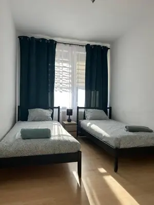 Łóżko lub łóżka w pokoju w obiekcie Apartament Słoneczny 3