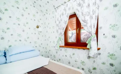 Łóżko lub łóżka w pokoju w obiekcie Apartamenty Romanowka