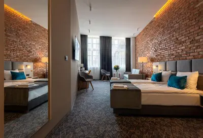 Łóżko lub łóżka w pokoju w obiekcie Korona Gold - Korona Hotel Wrocław
