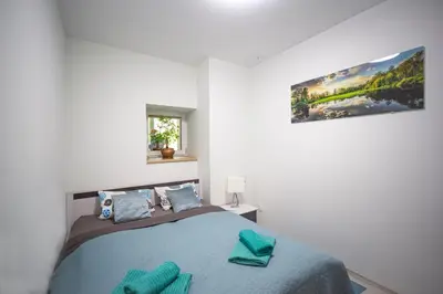 Łóżko lub łóżka w pokoju w obiekcie Apartament przy Parku
