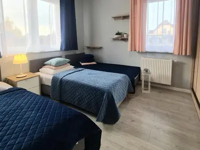 Łóżko lub łóżka w pokoju w obiekcie APARTAMENTY 