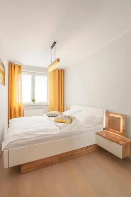 Łóżko lub łóżka w pokoju w obiekcie Apartament słoneczny